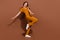 Full body photo of cheerful cool positive woman dance enjoy free time weekend isolated on brown color background