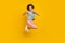 Full body photo of cheerful young happy woman jump up show thumb-up cool isolated on yellow color background