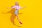 Full body photo of excited sportive girl run arms wings fly beaming smile isolated on yellow color background