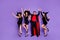 Full body photo of four members group witch ladies and warlock guy dancing at halloween event wear short dresses hats