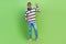 Full body photo illustration of peaceful young guy showing v sign greetings welcome team good morning isolated on green