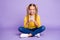 Full body photo of interested positive child sit crossed folded legs use her phone read follow blogging social media