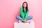 Full body photo of lovely cheerful lady sit cube look interested empty space ad  on pink color background