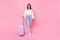 Full body photo of lovely young woman suitcase travel agency client smiling wear trendy white garment isolated on pink