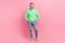 Full body photo of nice retired male hands pockets jeans model shopping dressed stylish green outfit isolated on pink