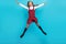 Full body photo of overjoyed carefree person jumping make star figure good mood  on blue color background