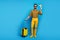 Full body photo positive bearded man enjoy tourism weekends hold orange papercard plane trolley travel air first-class