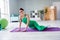 Full body photo of positive slender lady sit fitness carpet enjoy morning workout bright living room inside