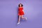 Full body photo of pretty jumping high lady wear red dress isolated purple background