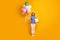 Full body photo of pretty lady hold colorful balloons big giftbox party blow noisemaker wear paper cone hat polka-dot