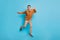 Full body photo of scared young man jump up air afraid wear glasses grimace isolated on blue color background