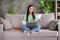 Full body photo of smart asian expert girl sit divan legs crossed folded work remote use laptop read project information