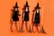 Full body photo of three cruel witch ladies holding brooms not showing evil facial expression wear black dresses and