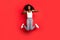 Full body photo of young afro girl happy positive smile jump up show thumb-up like fine advert isolated over red color