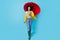 Full body photo of young afro woman happy positive smile go walk rainy wet hold parasol isolated over blue color