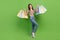 Full body photo of young funny fashionista shopaholic addiction girl raise hands with packages bags isolated on green