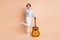 Full body photo of young girl amazed shocked surprised happy enjoy guitar artist isolated over beige color background