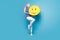 Full body photo of young girl happy positive hold paper pinata emoji smile look empty space isolated over blue color