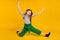 Full body photo of young girl happy positive smile acrobatics flexible show peace cool v-sign  over yellow color