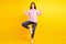 Full body photo of young lovely girl meditate yoga asana balance wear casual outfit isolated over yellow color