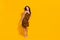 Full body photo of young pretty woman look empty space fancy luxury  over yellow color background