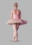 Full body portrait of ballerina dancer posing with grey background