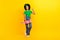 Full body portrait of cheerful friendly schoolgirl hold skateboard empty space  on yellow color background