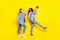 Full body portrait of two carefree excited buddies dark skin hold disco ball isolated on yellow color background