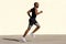 Full body profile of healthy young african american man running by wall