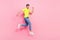 Full body profile photo of active brunet hairdo young guy run wear green t-shirt jeans isolated on pink color background