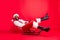Full body profile side photo of amused african santa claus in xmas cap screaming sledding wearing white pullover pants