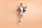 Full body profile side photo of attractive happy crazy man jump up air celebrate win isolated on beige color background