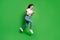 Full body profile side photo of crazy girl jump run read smartphone wear t-shirt denim isolated green color background