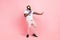 Full body profile side photo of young energetic handsome male dancing in nightclub isolated on pink color background