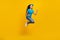 Full body profile side photo of young excited girl jump rejoice victory fists hands awesome isolated over yellow color