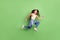 Full body profile side photo of young girl happy positive smile jump go walk run hurry isolated over green color