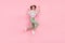 Full body profile side photo of young girl happy positive smile rejoice success jump isolated over pink color background