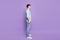 Full body profile side photo of young guy calm concentrated confident look empty space isolated over purple color
