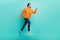 Full body profile side photo of young man runner hurry look empty space motion jump isolated over teal color background