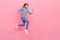 Full body profile side photo of youth lady runner energetic speed rush motion jump isolated over pink color background