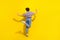 Full body rear photo of overjoyed crazy lady enjoy dancing chilling empty space isolated on yellow color background