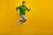 Full body size photo of running crazy young man hurry marathon race high speed jumper high motivation isolated on yellow