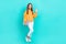 Full body size photo of teenager girl wear smart casual outfit hold netbook showing palm hello symbol isolated on