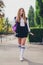 Full body vertical photo of charming teenager woman walking schoolgirl wear trendy uniform clothes nature green park