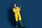 Full body view of attractive amazed girl walking cold british weather outfit direct fingers novelty isolated on blue