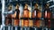 Full bottles with alcohol on a working machine at a factory. Whiskey, scotch, bourbon production.