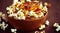 Full bowl of caramel popcorn drizzled with shiny golden caramel.