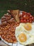 full breakfast with eggs, beans, toast, sausages and tomatoes
