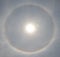 Full circle rainbow around Sun, rays catch the thin vapour formed of ice crystals