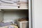 Full closet with clothes and Stack of towels in white wooden closet, organization and storage